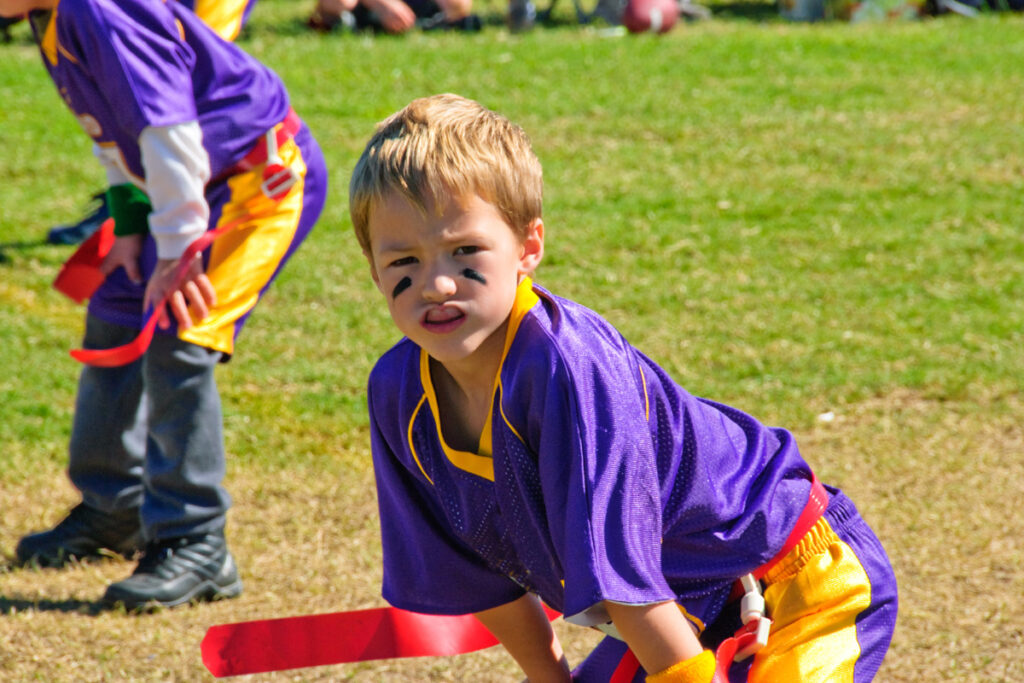 Kids with mouth guards playing football