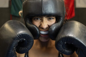 female boxer trained and using mouth guard and face shield